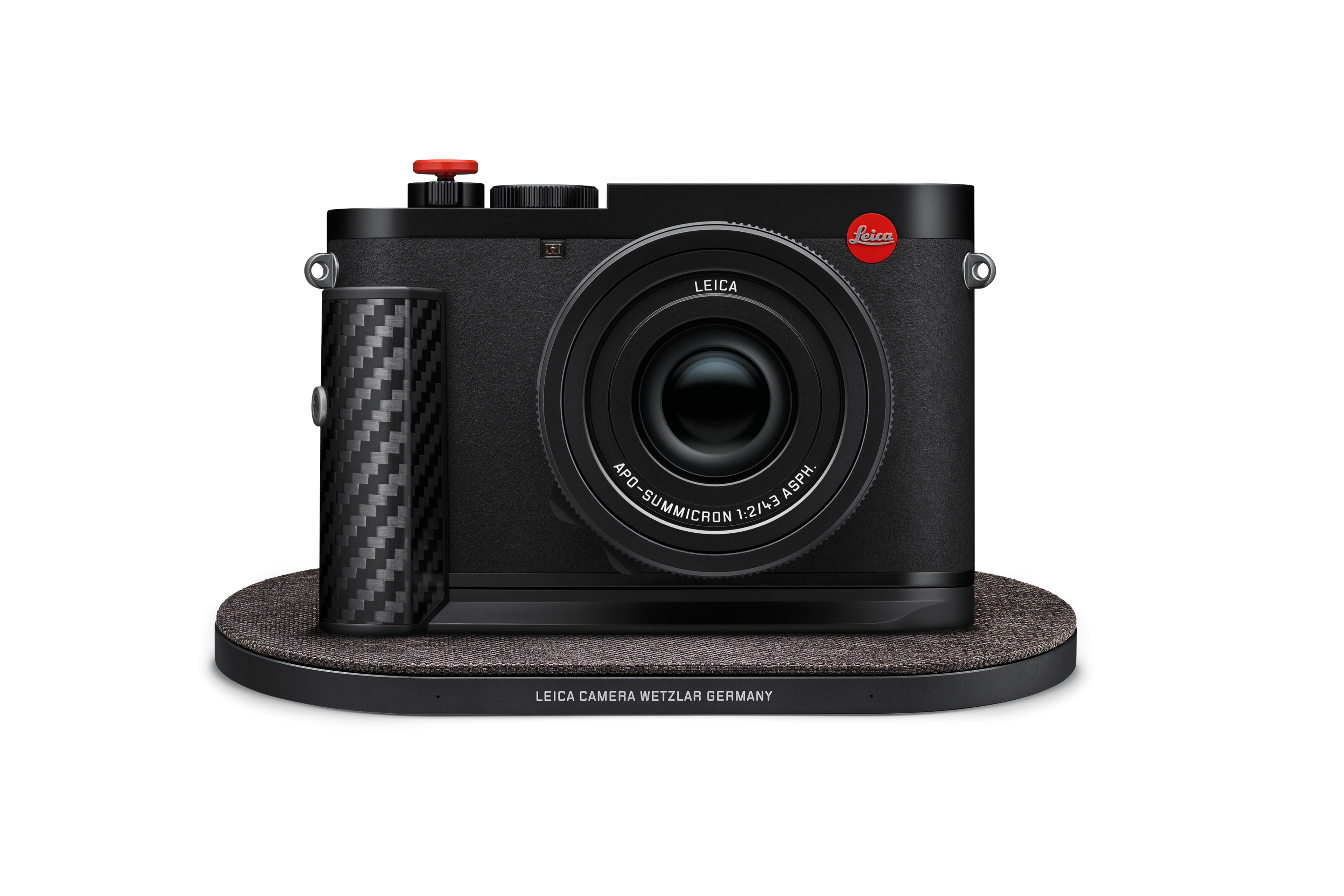 Leica Q3 43 F1 Sonderedition auf einer kabellosen Ladestation mit Leica-Schriftzug, Carbon-Griff und APO-Summicron 43 mm Objektiv.